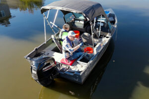 Bowman environmental scientist team in water on boat collecting samples on water quality