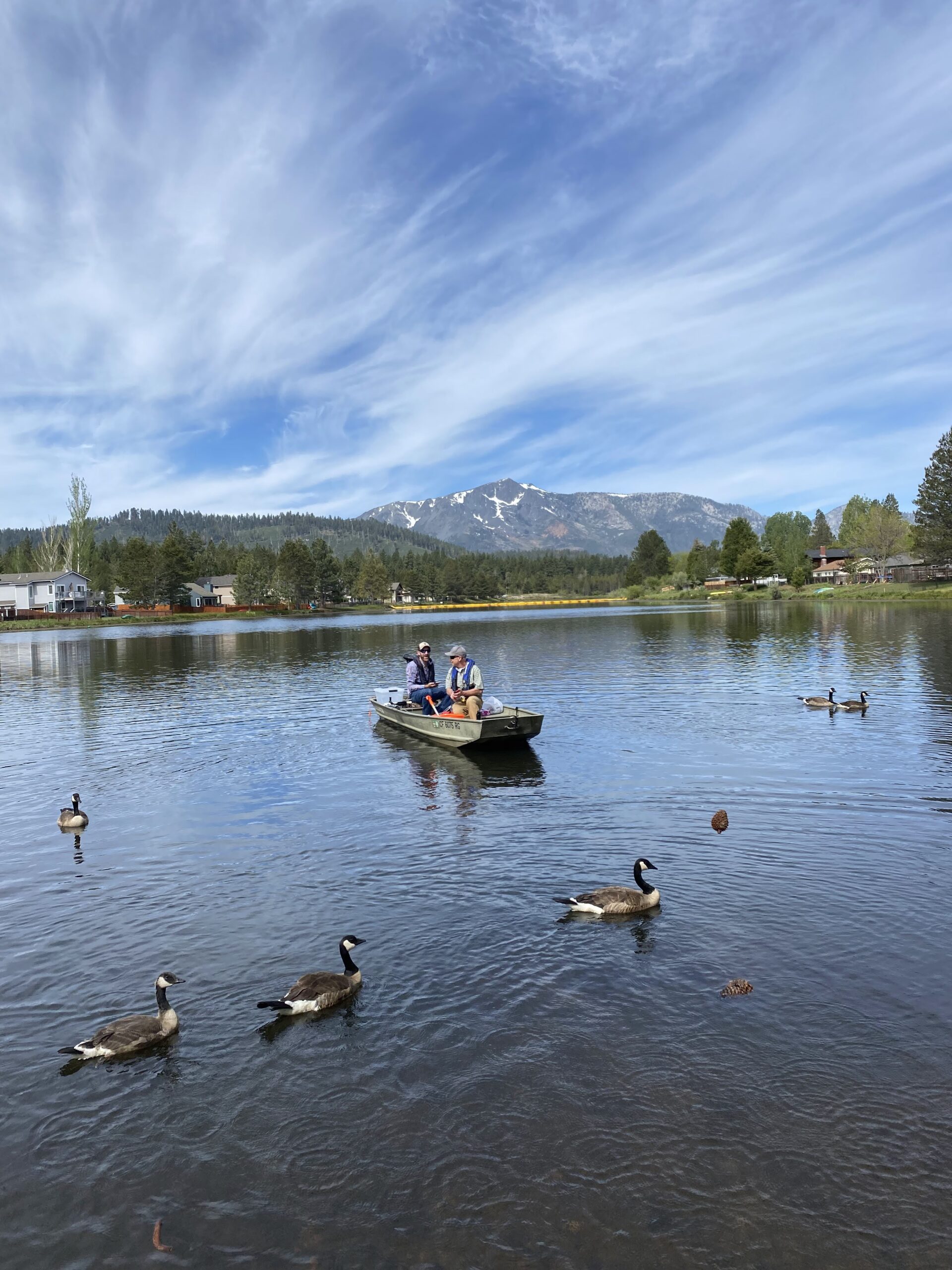 Bowman environmental scientist team in water on boat collecting samples on water quality