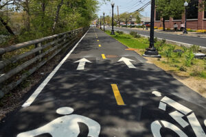 View of walking path and bike lane on section of Woonasquatucket River Greenway in RI.